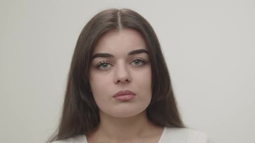 Closeup Portrait of Sad Brunette Girl Front View of Upset Young Woman Looking at Camera Isolated on