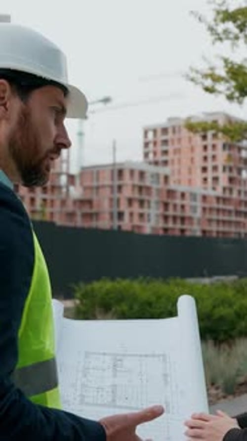 Two Contractors Civil Engineers Checking Blueprint Discuss Buildings Project Teamwork Woman Man