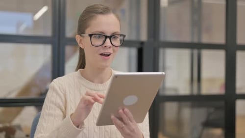 Portrait of Woman with Success on Tablet