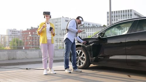 Couple Uses VR Headsets While Charging Electric Car