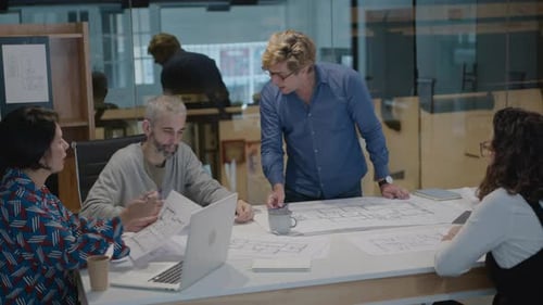 Mature Architects Discussing Floor Plans in the Office