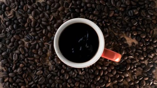 Overhead Shot of Coffee Surrounded by Coffee Beans
