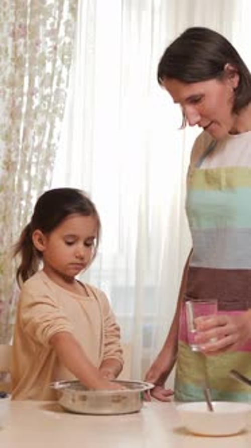 Child and Mother Cooking Together at Home