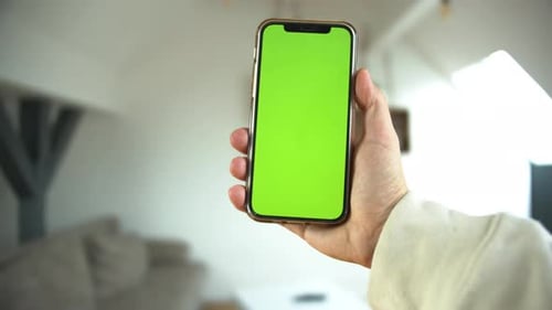 Hand Holding Smartphone with Green Screen
