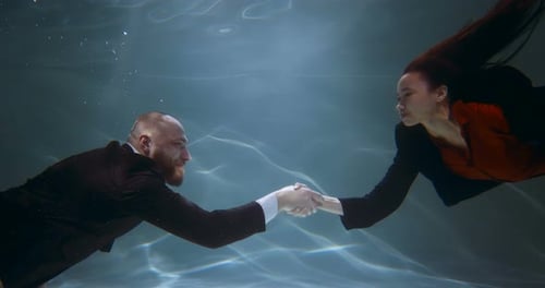 Underwater Handshake Between Business Man and Woman