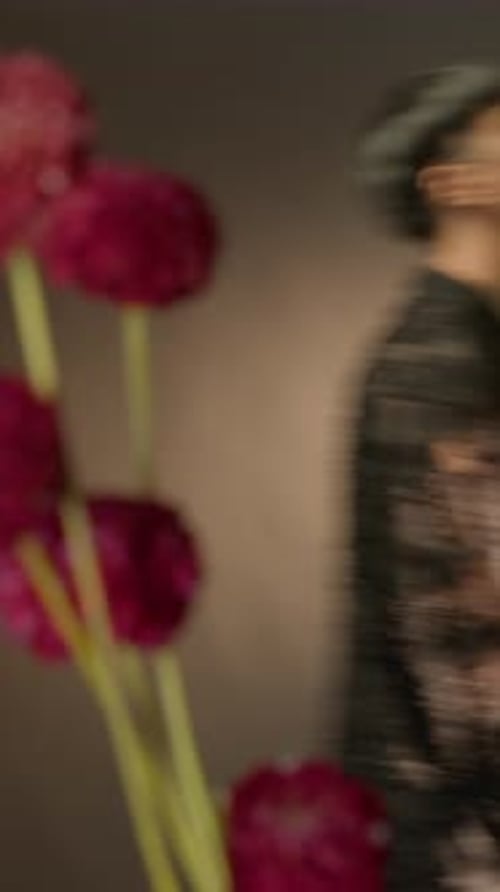 Young Adult Posing with Flowers Indoors