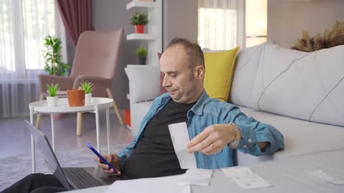 Family man is trying to pay bills and debts and is worried.