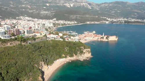 Budva old town in Montenegro on the coastline of the Adriatic Ocean on a sunny day. Camera panning u