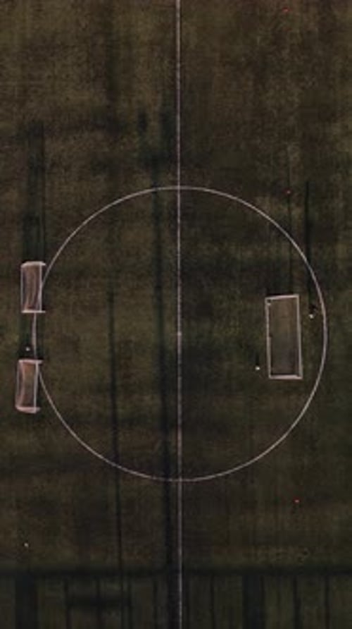 Aerial view of a soccer game on a grassy field during daylight