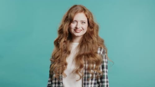Smiling Woman with Long Curly Auburn Hair