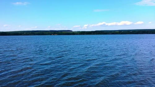 Crossing the river and following to the waterfront. Sunny day in nature.