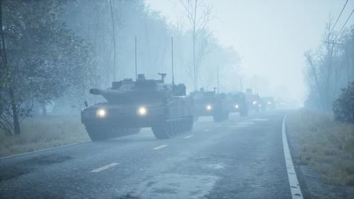 Military Tank Convoy Drives Through a Foggy Road