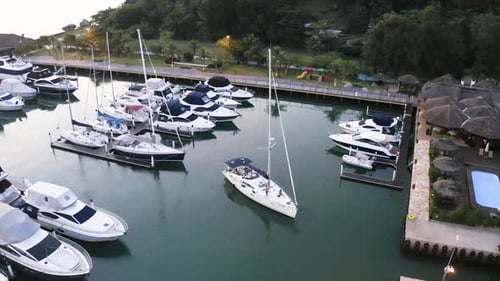Sailboat maneuver at a marina in the sunset