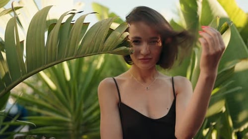 Stylish Woman Posing in Tropical Plant Setting