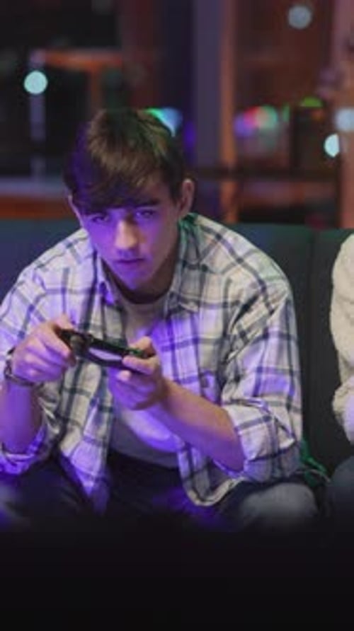 Young Adult Gaming at Home at Night