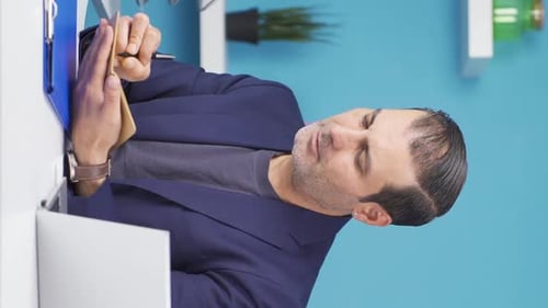 Vertical video of Businessman doing economic calculations.