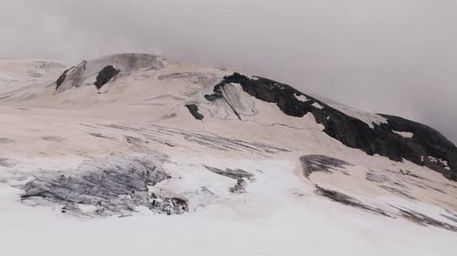 Exploring Breathless Snowy Mountain Peaks and Ancient Glaciers Under Cloudy Skies