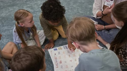 Intercultural Children Learning Alphabet with Tutor in Kindergarten