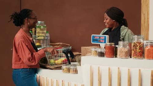 Customer Purchasing Produce From Cashier at Store Counter