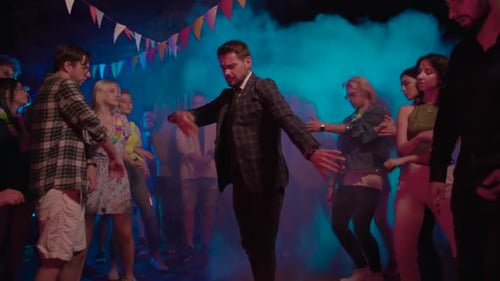 Enthusiastic People Dancing Together at an Evening Party