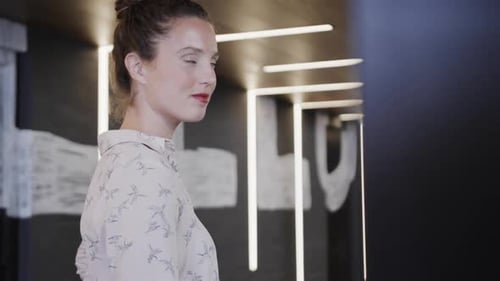 Portrait of happy caucasian casual businesswoman in office, slow motion