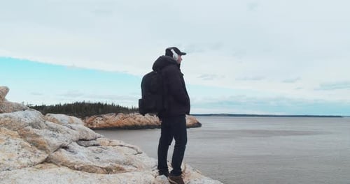 Traveler on a Rock Looks at the Ocean