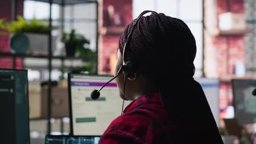 Call Center Worker in Office Using AI Chatbot to Reply to Customers