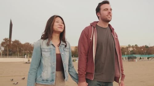 Young couple walking along the beach