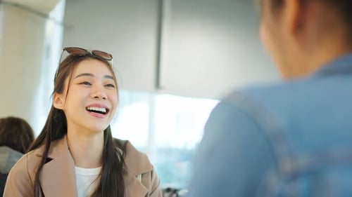 Young Woman Chatting at Bright Modern Workplace