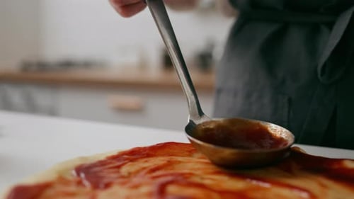 Applying Red Sauce On Pizza Dough, Preparing Pizza For Baking Pizza Cooking Process Adding Red Chili