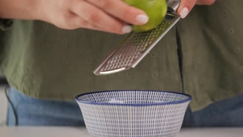 Zesting a lime with a food grater.