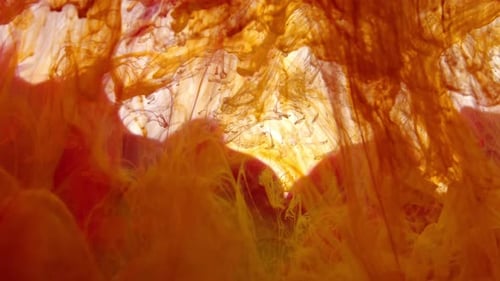 Abstract Orange and Yellow Ink Mixing Slowly