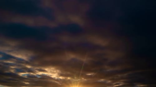 Sunset with Sun and Clouds on Blue and Orange Dramatic Sky with Sun Rays Night Sunset Sky Timelapse