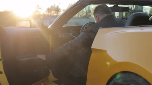 Sunset Drive in a Convertible Car Man Opening the Door of a Convertible Car During a Beautiful