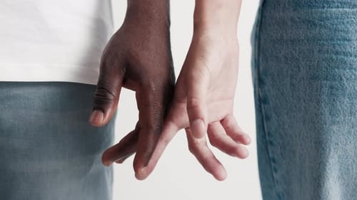 Intertwined Fingers of Diverse Pair Close Up