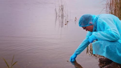 Scientist Takes Water Sample from Pond