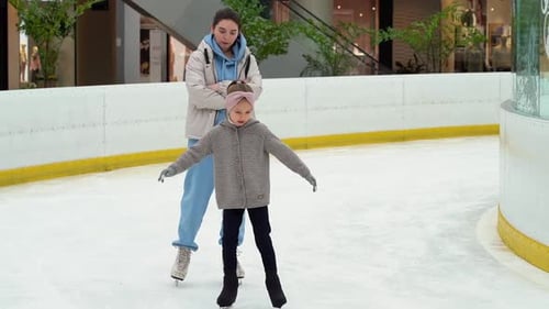 Figure Skating Coach Works with Girl at Ice Rink Childrens Sport