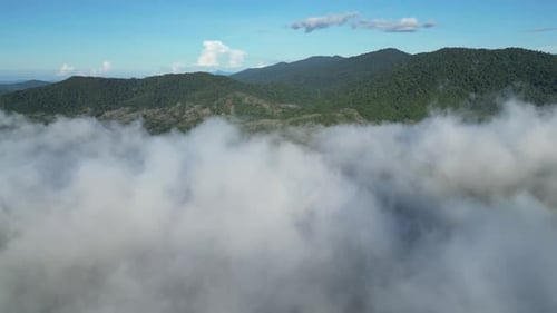 Aerial scene of idyllic morning landscape featuring low clouds and distant hill