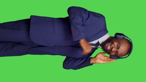 Vertical Video Side View of Young Adult Using Headphones and Listening to Music