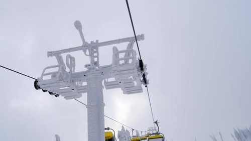 POV ride on chairlift passing frozen supporting tower in Skrzyczne, Poland