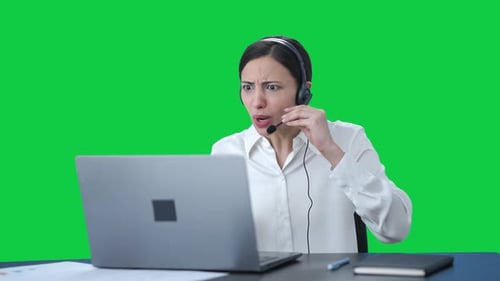 Angry Indian call center girl talking to customer through call Green screen