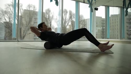 Fitness Woman in a Bright Studio Doing an Exercise to Increase Flexibility Relaxation and Wellbeing