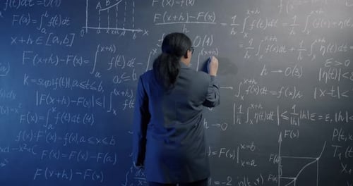 African American Science Teacher Walking to Chalk Board and Writing Maths Formula Calculating