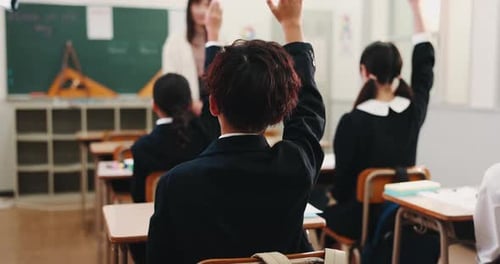 Students Raise Hands in Japanese Classroom