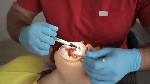 Dentist Performing an Orthodontic Procedure on Patient