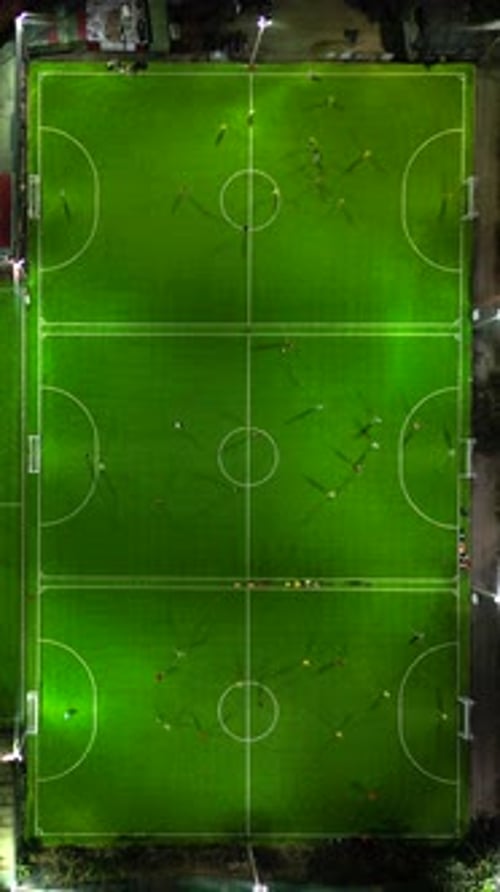 Aerial View of Football Pitches During Evening Matches