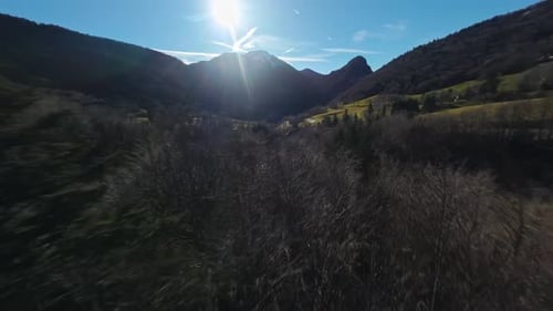 Aerial view of a mountain behind a mountain forest