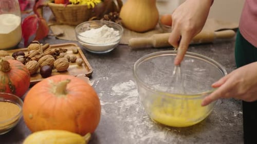 Hands Cooking Pumpkin Pie Making Dough Mix Eggs and Sugar in Bowl with Whisk
