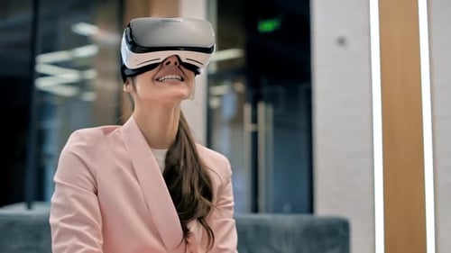 A blonde caucasian woman exploring virtual reality using VR glasses in an office