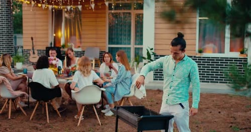 Group of Multiethnic People Resting in Patio Man Setting Fire in Grill Friends Party Prores